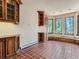 Spacious office features built-in wooden cabinets and terracotta tile floors at 26600 Mowbray Ct, Evergreen, CO 80439