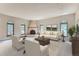 Living room with fireplace and large windows offering a view of the woods at 26600 Mowbray Ct, Evergreen, CO 80439