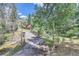 Stone driveway leading to a charming home with a gated entrance at 26600 Mowbray Ct, Evergreen, CO 80439