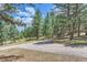 Private circular driveway with landscaping and trees at 26600 Mowbray Ct, Evergreen, CO 80439