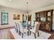 Elegant dining room featuring a large glass table, chandelier, and a beautiful hutch at 26600 Mowbray Ct, Evergreen, CO 80439