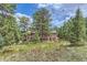 A stunning two-story home nestled among tall pine trees at 26600 Mowbray Ct, Evergreen, CO 80439