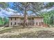 Backyard view of a large, beautiful two-story home with a covered patio at 26600 Mowbray Ct, Evergreen, CO 80439