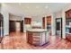 Large kitchen with an island, double ovens, and terracotta tile floors at 26600 Mowbray Ct, Evergreen, CO 80439