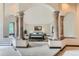 Main bedroom with ornate columns and a luxurious feel at 26600 Mowbray Ct, Evergreen, CO 80439