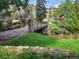 Landscaped grounds with a quaint bridge crossing a waterway at 26600 Mowbray Ct, Evergreen, CO 80439