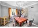Bright dining room with hardwood floors, an elegant chandelier, and a view to the living room at 2371 Locust St, Denver, CO 80207