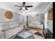 Living room with hardwood floors, ceiling fan, and comfortable seating at 2371 Locust St, Denver, CO 80207