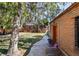 Brick building and grassy backyard with mature trees at 2371 Locust St, Denver, CO 80207