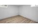 Unfinished basement room with light wood-look flooring at 2371 Locust St, Denver, CO 80207
