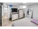 Finished basement bedroom with large TV and ample storage at 2371 Locust St, Denver, CO 80207