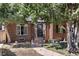 Brick home with a charming front porch and landscaped yard at 2371 Locust St, Denver, CO 80207