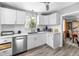 Modern kitchen with white cabinets, stainless steel appliances and quartz countertops at 2371 Locust St, Denver, CO 80207