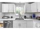 Modern kitchen with white cabinets, stainless steel appliances and quartz countertops at 2371 Locust St, Denver, CO 80207