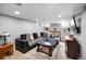 Finished basement recreation room with sectional sofa, built-in shelving, and large TV at 2371 Locust St, Denver, CO 80207