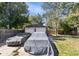 Two-car detached garage and a grassy backyard with trees at 2371 Locust St, Denver, CO 80207