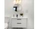 Clean bathroom with a floating vanity and a round mirror at 17004 E Tennessee Dr # 210, Aurora, CO 80017