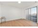 Spacious bedroom with hardwood floors and access to a balcony at 17004 E Tennessee Dr # 210, Aurora, CO 80017