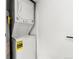 Compact laundry area with stacked washer and dryer at 17004 E Tennessee Dr # 210, Aurora, CO 80017