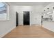 Open living area with hardwood floors and a view into the kitchen at 17004 E Tennessee Dr # 210, Aurora, CO 80017
