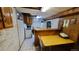 Basement kitchen with white appliances and wood cabinets at 7820 Mccella Ct, Westminster, CO 80030