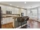 Eat-in kitchen with island and breakfast bar, lots of cabinet space at 11590 S Maiden Hair Way, Parker, CO 80134