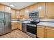 Kitchen with stainless steel appliances and wood cabinets at 660 S Alton Way # 3B, Denver, CO 80247