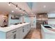 Large kitchen island with white cabinets and black hardware at 11922 W 77Th Dr, Arvada, CO 80005