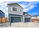 Two-car garage and front exterior of two-story home at 2174 Farmlore Dr, Brighton, CO 80601