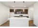 Modern kitchen with island, stainless steel appliances, and dark brown cabinets at 2174 Farmlore Dr, Brighton, CO 80601