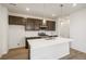 Modern kitchen with island, stainless steel appliances, and dark brown cabinets at 2174 Farmlore Dr, Brighton, CO 80601