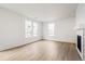 Spacious living room featuring hardwood floors and a fireplace at 2174 Farmlore Dr, Brighton, CO 80601