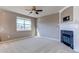 Living room with fireplace, neutral carpet, and large window at 3672 S Perth Cir # 101, Aurora, CO 80013