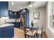 Modern kitchen with navy cabinets, stainless steel appliances, and quartz countertops at 2120 S Vaughn Way # 201F, Aurora, CO 80014