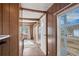 Hallway with wood paneling and access to other rooms in the mobile home at 1219 Lilac Dr, Lochbuie, CO 80603