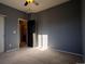 Bedroom with carpet, neutral walls, and a door to a bathroom at 10935 Acadia, Parker, CO 80138