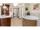 Primary bathroom with double vanity and large soaking tub at 7846 Village Rd, Parker, CO 80134