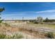 Open pasture land with white post and rail fencing at 7846 Village Rd, Parker, CO 80134