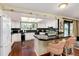 Kitchen with granite countertops, white cabinets, and breakfast bar at 7846 Village Rd, Parker, CO 80134