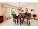 Elegant dining room featuring a large table, chandelier, and window views at 7846 Village Rd, Parker, CO 80134