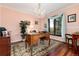 Elegant home office with hardwood floors, large window, and ornate desk at 7846 Village Rd, Parker, CO 80134