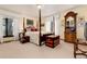 Spacious bedroom with a four poster bed and window views at 7846 Village Rd, Parker, CO 80134