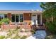 Brick ranch house with a welcoming front porch and landscaped yard at 7846 Village Rd, Parker, CO 80134