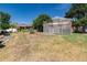 Spacious backyard with a wooden arbor and a large grassy area at 7846 Village Rd, Parker, CO 80134