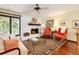 Living room with hardwood floors, fireplace, and comfortable seating at 7846 Village Rd, Parker, CO 80134