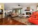 Living room with hardwood floors, fireplace, and comfortable seating at 7846 Village Rd, Parker, CO 80134