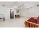 Unfinished basement area with a futon and sink at 7846 Village Rd, Parker, CO 80134