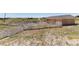 Exterior view of a barn with white fencing at 7846 Village Rd, Parker, CO 80134