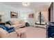 Bright living room featuring a comfy sofa and large window at 7846 Village Rd, Parker, CO 80134