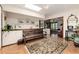 Spacious entryway with tile floors, a wooden bench, and views to the living room at 7846 Village Rd, Parker, CO 80134